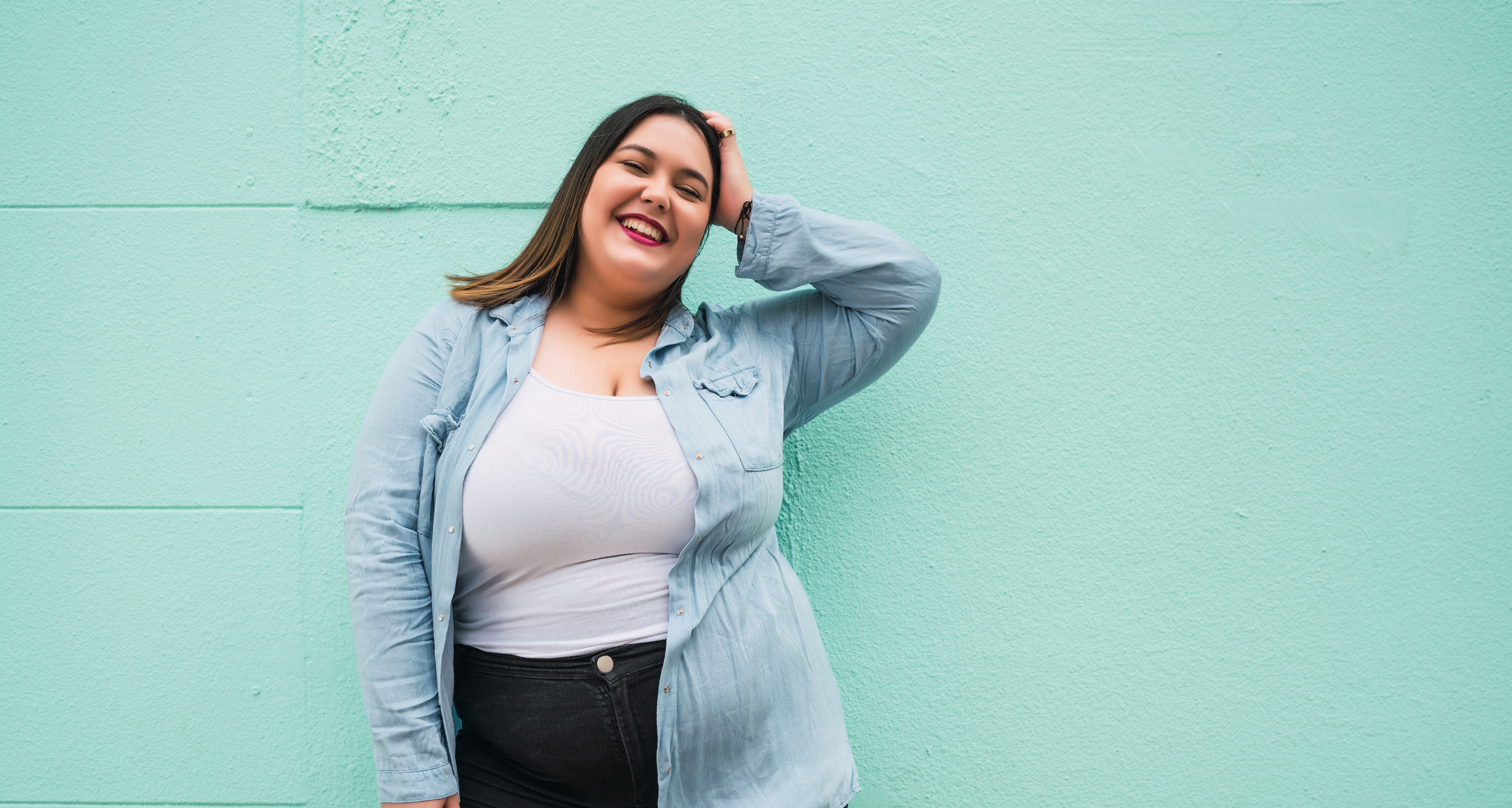 Smiling woman in a striped shirt and denim jacket