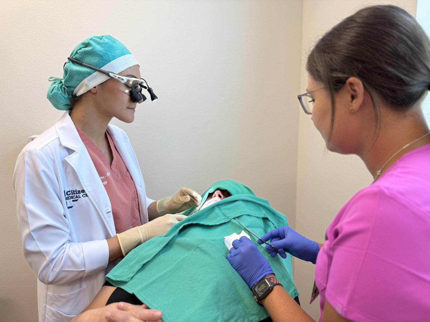 Dermatology team performing a procedure