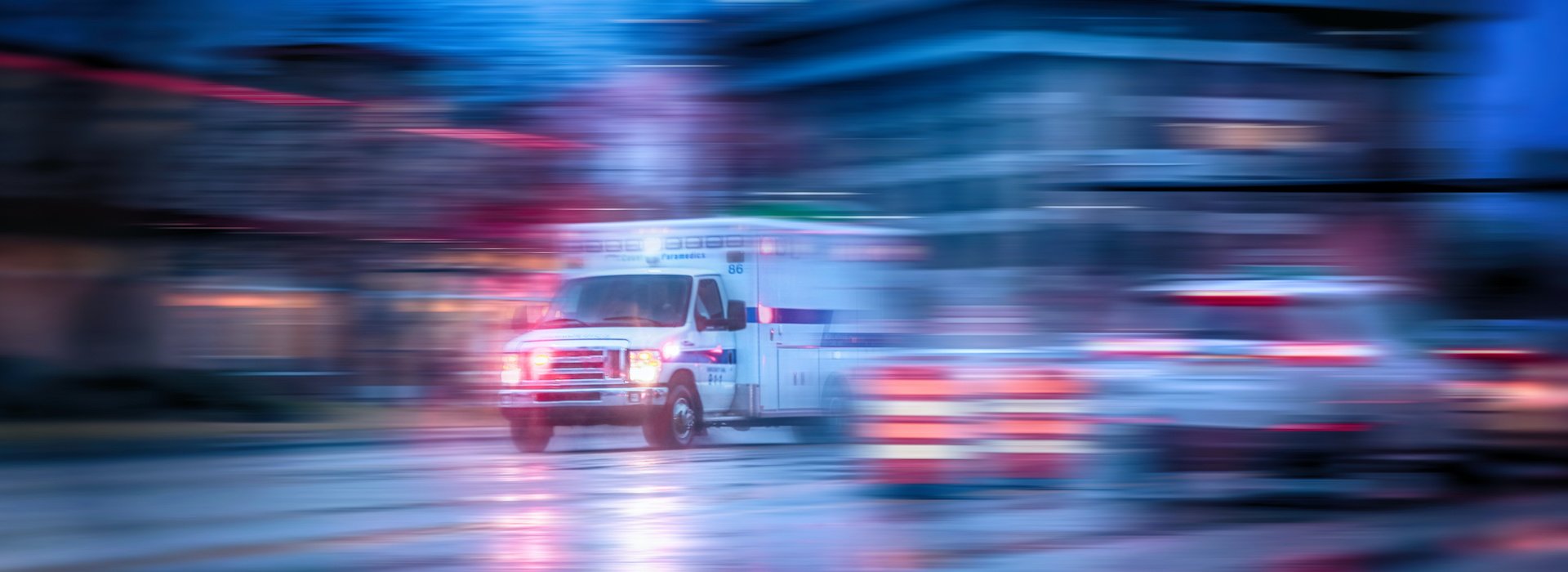 Ambulance traveling through traffic with emergency lights