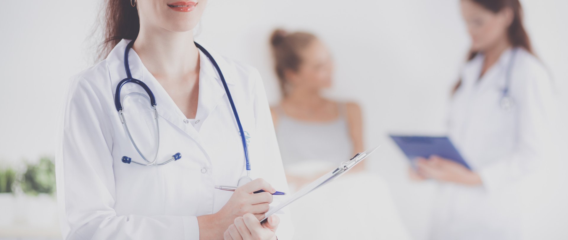 Hospitalist holding a clipboard in a hospital setting