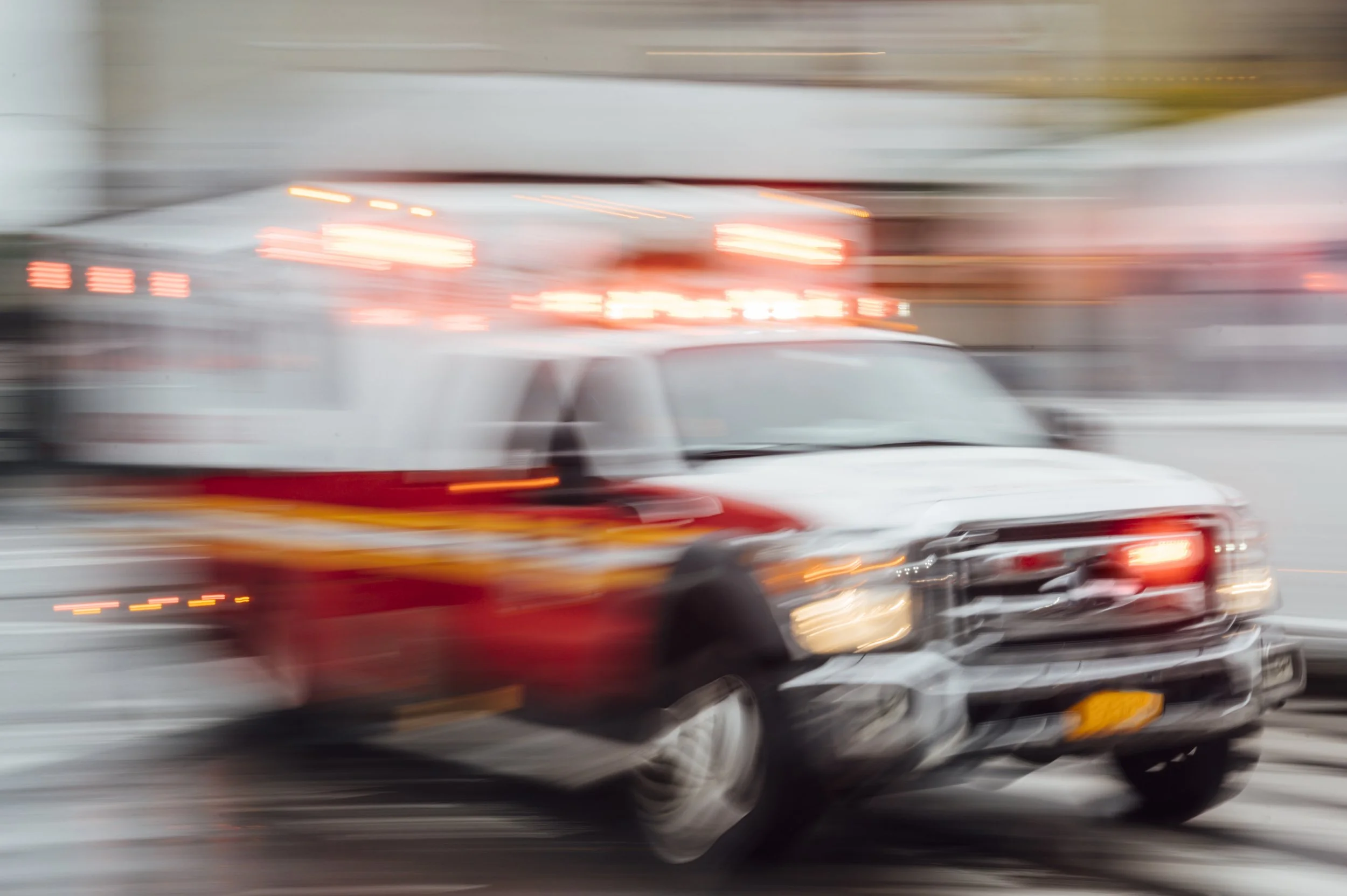 Ambulance travelling at high speed through a city street